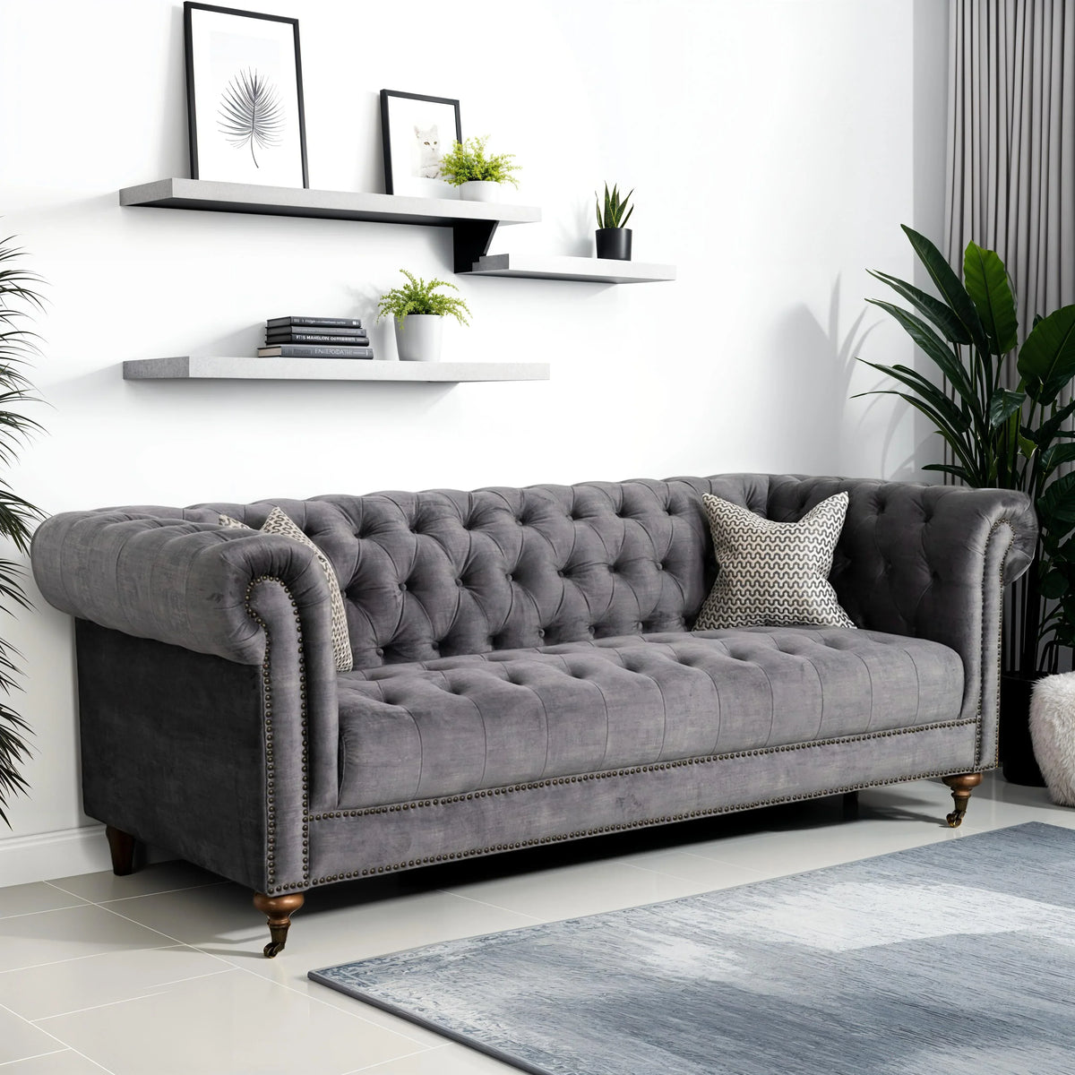 Grey tufted 4 seater Chesterfield sofa in a modern living room with wall shelves.