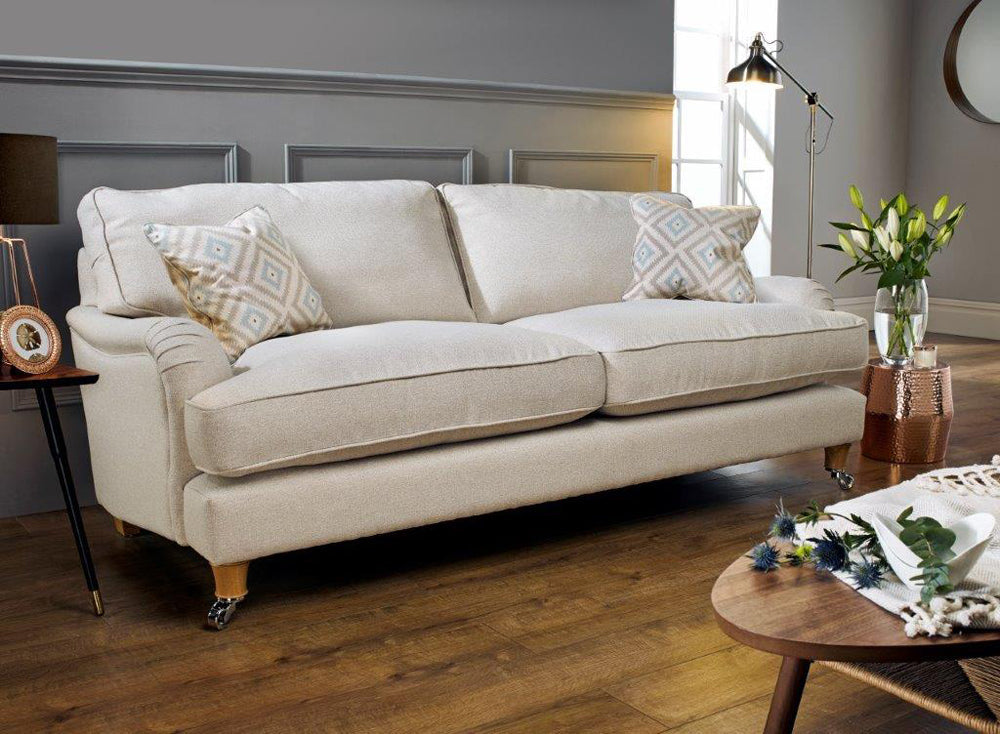 Beige Mayfair sofa with patterned cushions in a modern living room setting