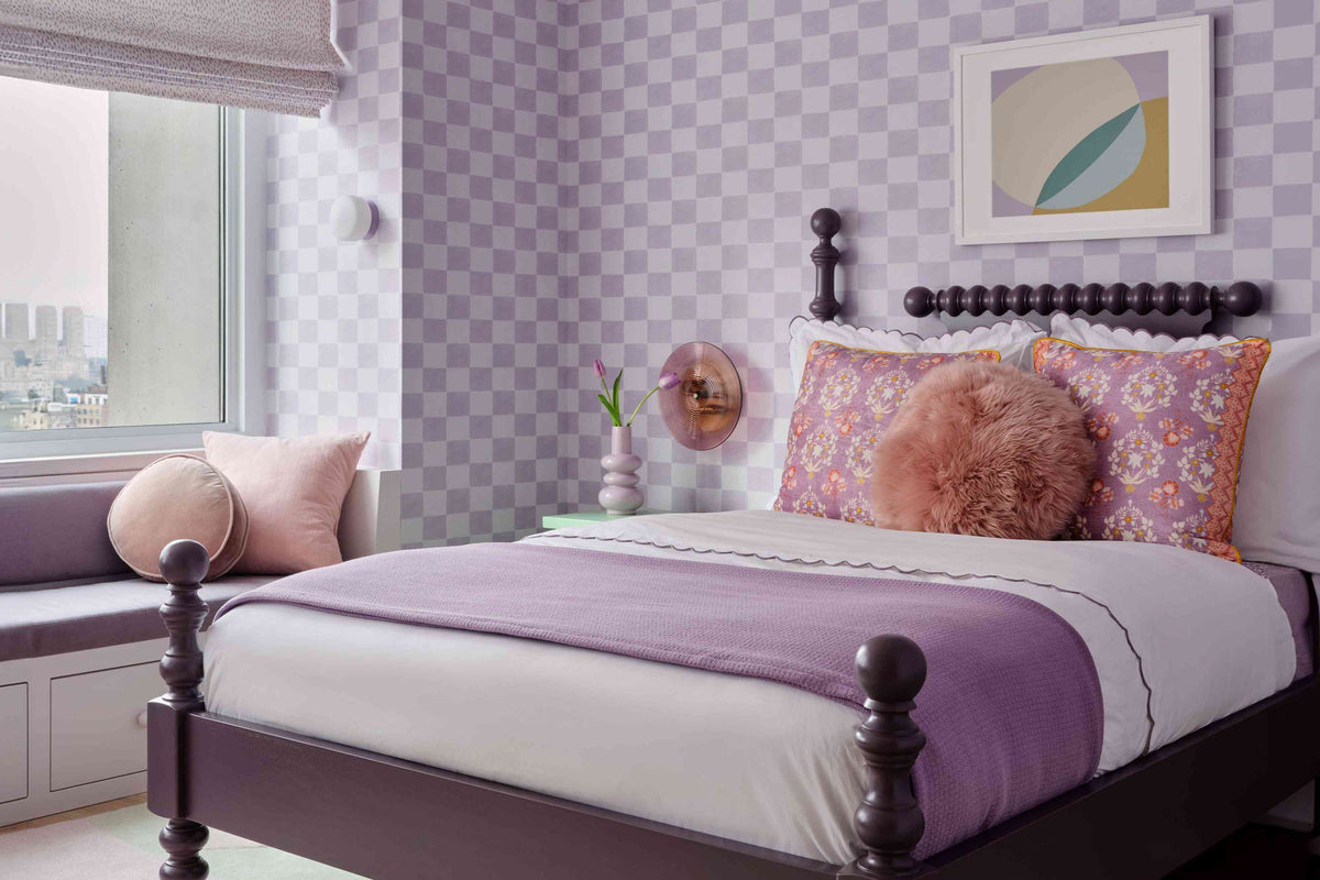 Modern teen bedroom with a purple bed, checkered wallpaper, and a cozy window seat.